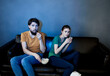 © SHOTPRIME STUDIO - A man and a woman are watching a movie in the cinema on the sofa indoors