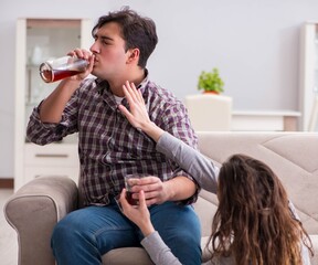 Wall Mural - Drinking problem drunk husband man in a young family concept