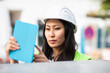 young construction engineer woman with helmet working outside