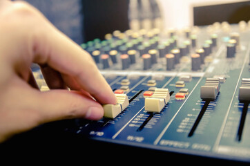 Wall Mural - Audio mixer console and professional sound mixing with buttons and sliders.