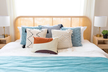 Wall Mural - close up of new bed comfort with decorative pillows ,headboard and side table lamp.