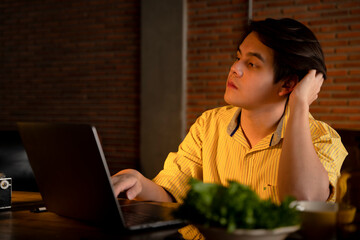 Business man working on computer laptop overtime at night.