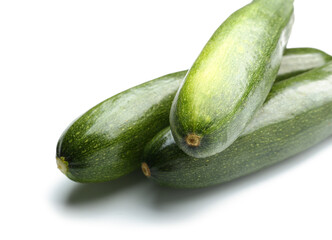 Fresh zucchini squashes on white background