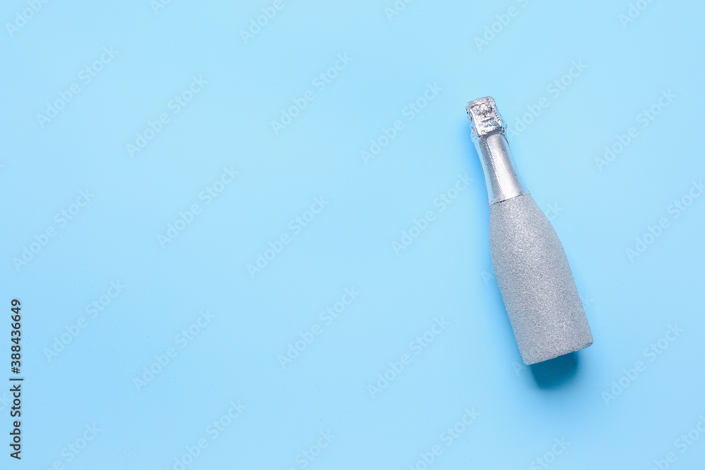 Bottle of champagne on color background. New Year celebration