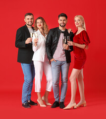 Poster - Young people with glasses of tasty champagne on color background