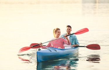 Wall Mural - Young couple kayaking in river