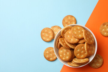 Bowl with cracker biscuits on two tone background