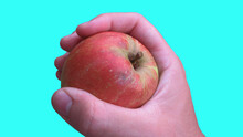 A Close Up Of A Male Hand Holding Red Apple