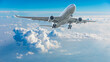 © ABCDstock - Commercial airplane flying above blue sky and white clouds.