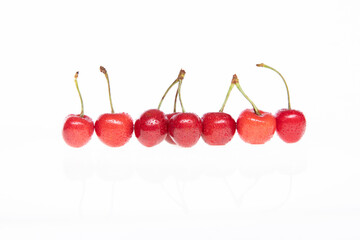 red raw fresh cherries on white background, close view 