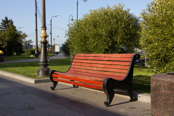 Close-up of a park bench on the autumn promenade