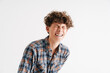© Drobot Dean - Young curly guy in plaid shirt laughing and screwing up his eyes
