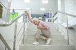 © zinkevych - Elderly woman in pink shirt falling down on the stairs