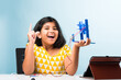 © StockImageFactory - Electronic experiment - Indian girl student working with wires and connections making windmill model