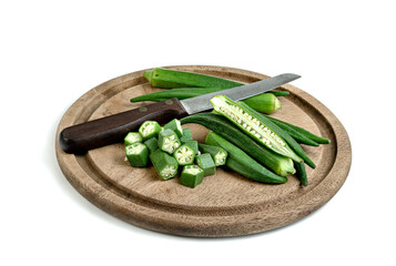 Poster - okra slice and knife on wooden tray isolated on white background