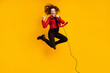Full length body size view of nice cheerful ecstatic cool crazy wavy-haired girl jumping singing showing horn sign isolated on yellow color background