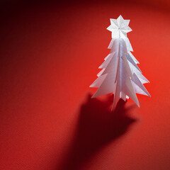 Wall Mural - Christmas trees made of paper on red background. Christmas card