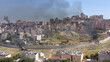 © ImageBank4U - Israel and Palestine divided by wall with smoke and firepisgat zeev and anata refugees camp, Jerusalem Israel-Aerial view