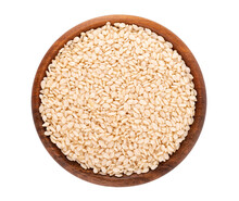 Sesame Seeds In Wooden Bowl, Isolated On White Background. Organic Dry Sesame Seeds. Top View.