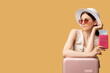 Holiday journey. Flight check-in. Summer travel. Advertising background. Woman sunglasses hat leaning suitcase holding foreign passport tickets looking copy space isolated on beige.