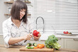 © puhimec - Young beautiful woman preparing fresh vegetable salad. Healthy food and diet concept.