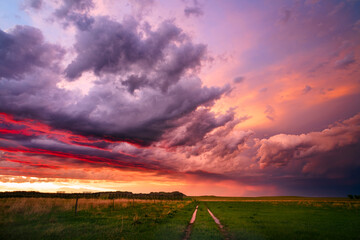 Wall Mural - colorful sunset sky behind a passing storm