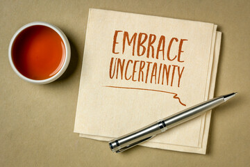 Canvas Print - embrace uncertainty motivational note - handwriting on a napkin with a cup of tea, unknown future, change, risk and chance concept