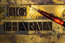 Big Pharma Text Message With Drop Of Red Fluid On Tip Of Syringe On Vintage Textured Gold Background