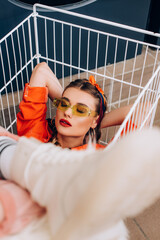 Sticker - stylish woman sitting in cart with blurred foreground