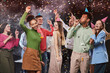 © Friends Stock - Group of young happy multiracial people dancing and having fun, confetti falling in the air