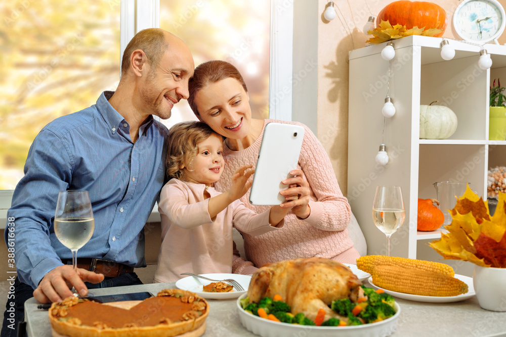 A happy family have a thanksgiving dinner and sends a video greeting to their parents.