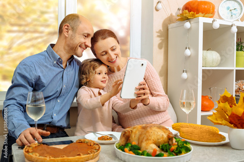 Cuadros en Lienzo A happy family have a thanksgiving dinner and sends a video greeting to their parents