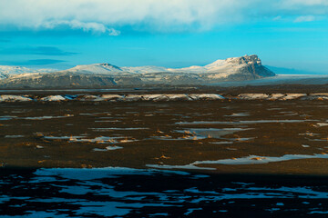 Wall Mural - Iceland's incredible fields and plains landscape in winter. The ground is covered with snow. Large spaces. The beauty of winter nature