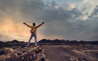 Wall Mural - Hiker celebrating success on top of a mountain at sunset - Success, winner and sport concept.