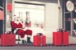 © alphaspirit - Santa Claus busy with the orders of Christmas gifts in a warehouse