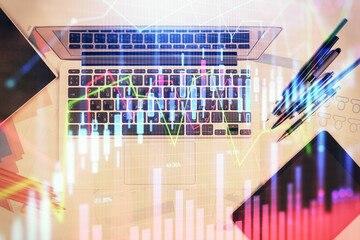 Multi exposure of forex chart drawing over table background with computer. Concept of financial research and analysis. Top view.