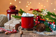 Red Mug On The Background Of Christmas Decor. Christmas Card. Happy New Year.