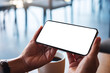 © Farknot Architect - Mockup image of a woman holding mobile phone with blank white desktop screen