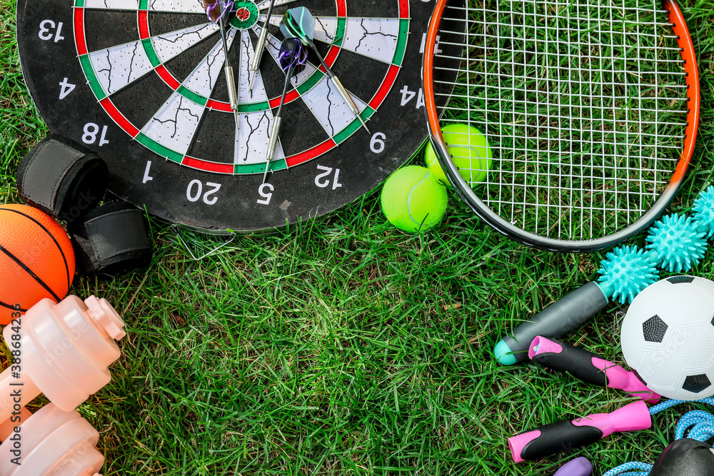Set of sport equipment on green grass