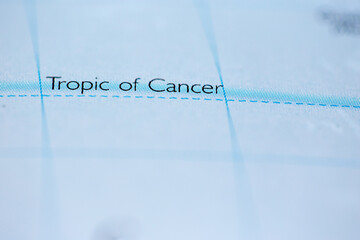 shallow depth of field focus on geographical map location of tropic of cancer line on atlas