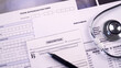 © Maksim Shchur - Prior authorization form, report of analysis form, x-ray picture and prescription blank next to the stethoscope and pen