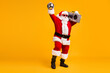 Full size photo of cool santa claus with grey beard listen x-mas christmas songs boom box hold disco ball in night club wear headwear cap isolated over yellow color background