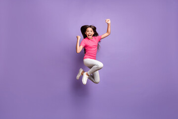 Wall Mural - Full length body size photo of jumping high cute little girl celebrating win cheering shouting smiling isolated on purple color background