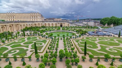 Wall Mural - Famous palace Versailles with beautiful gardens and fountains timelapse from top. The Palace Versailles was a royal chateau. It was added to the UNESCO list of World Heritage Sites. Paris, France.