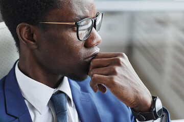 Wall Mural - Close-up of African businessman in eyeglasses thinking about something