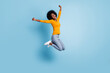 Photo portrait full body of excited girl celebrating jumping up isolated on pastel blue colored background
