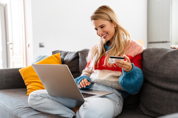 Lovely young attractive woman relaxing on a couch