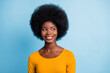© deagreez - Photo of lovely black young girl look side empty space beaming smiling wear yellow shirt isolated blue color background