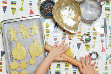 Kids are baking cookies in the kitchen the children are having fun adding ingredients to cook the food