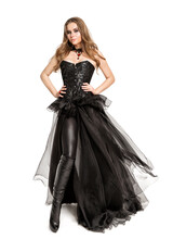 Beautiful Gothic Woman In Black Leather Costume, Wearing Latex Pants, Chiffon Dress, Black Corset Cut Out White Background